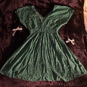 green mini flowy dress with accents of blue and white flowers